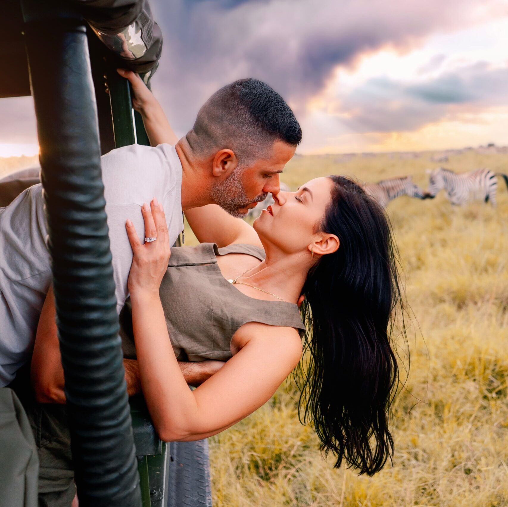 Romantic couple kissing during a safari adventure in Nairobi, Kenya.