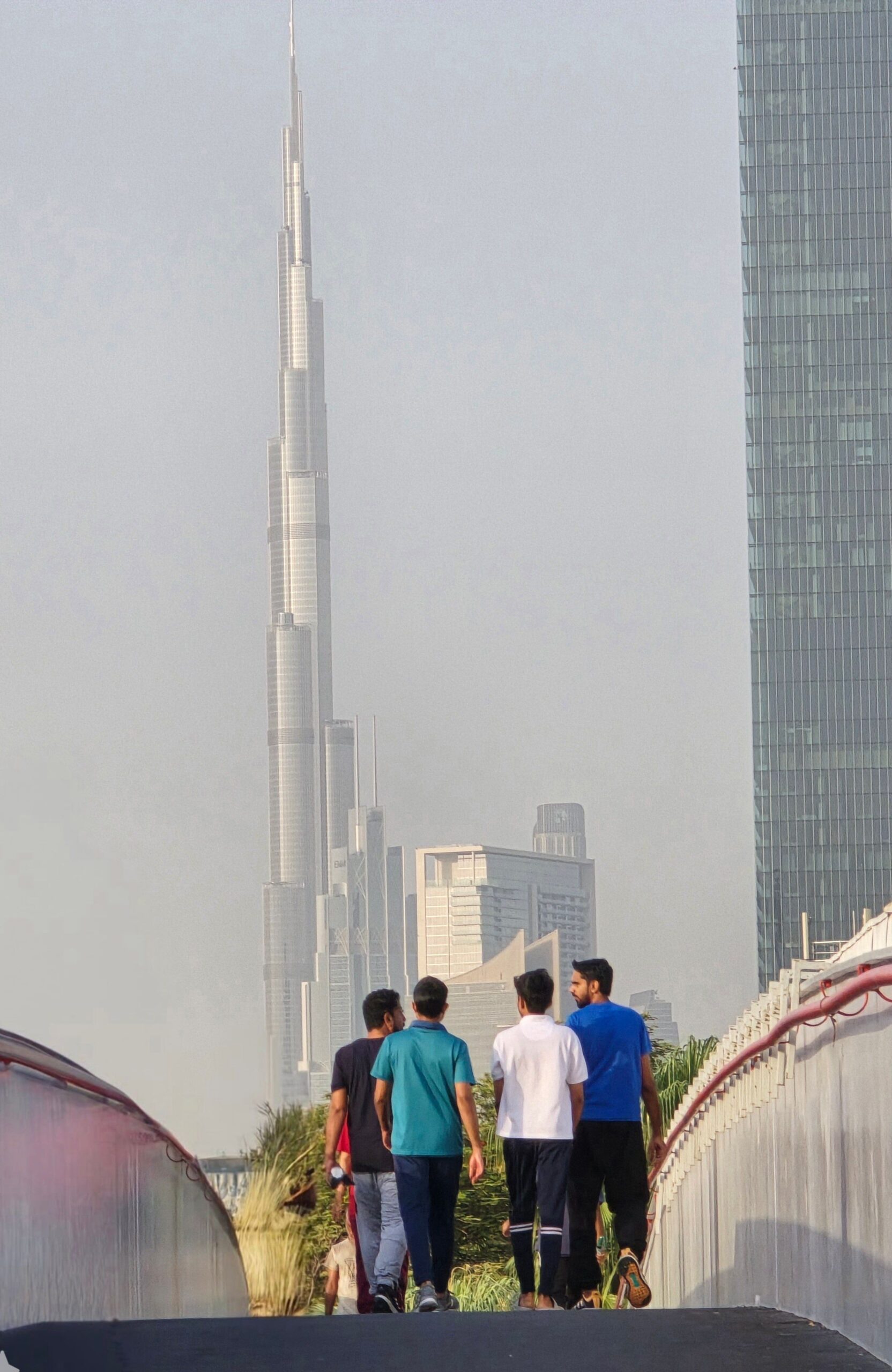 Group of friends walking with Burj Khalifa in the Dubai skyline.